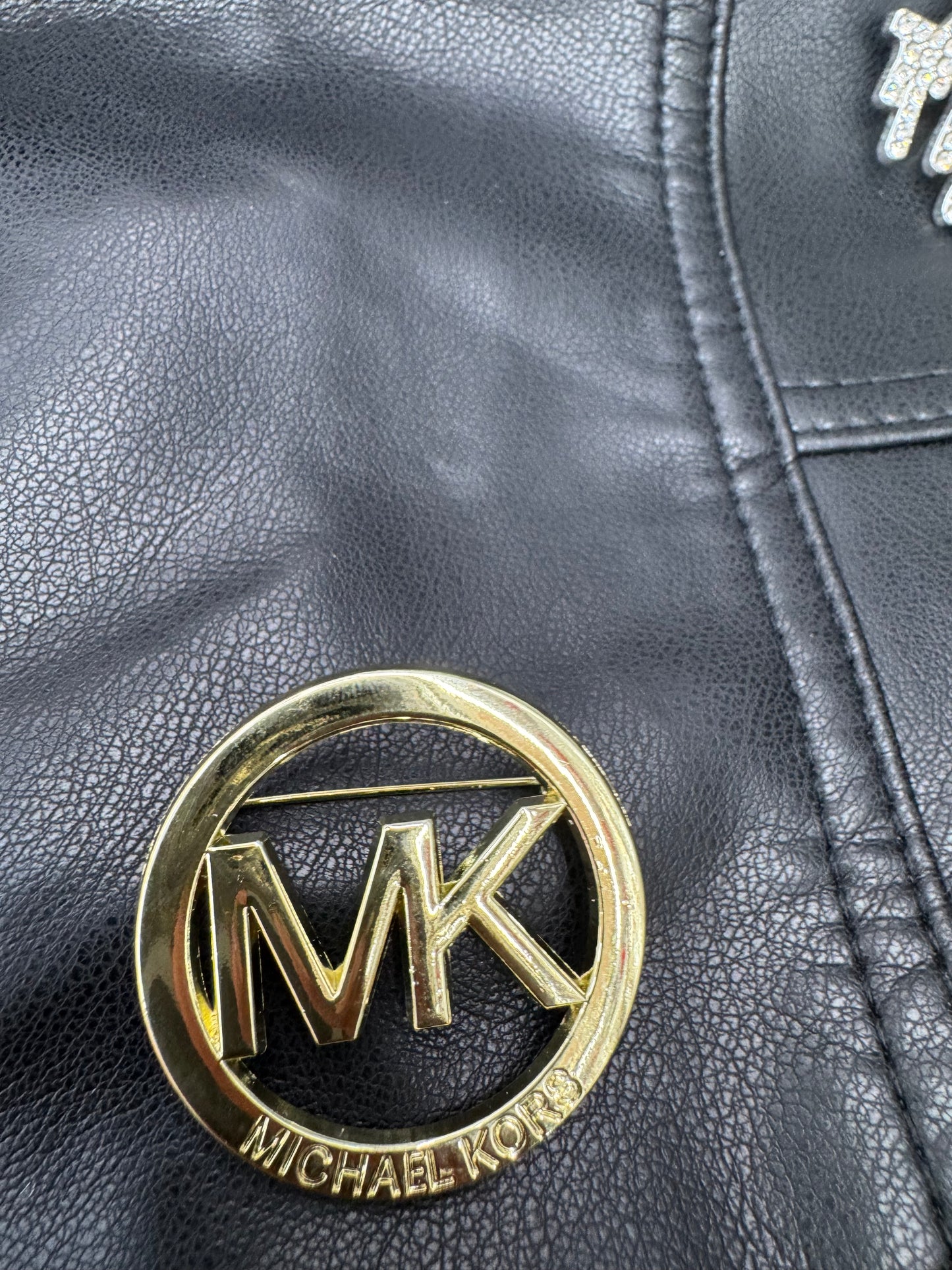 MK brooch