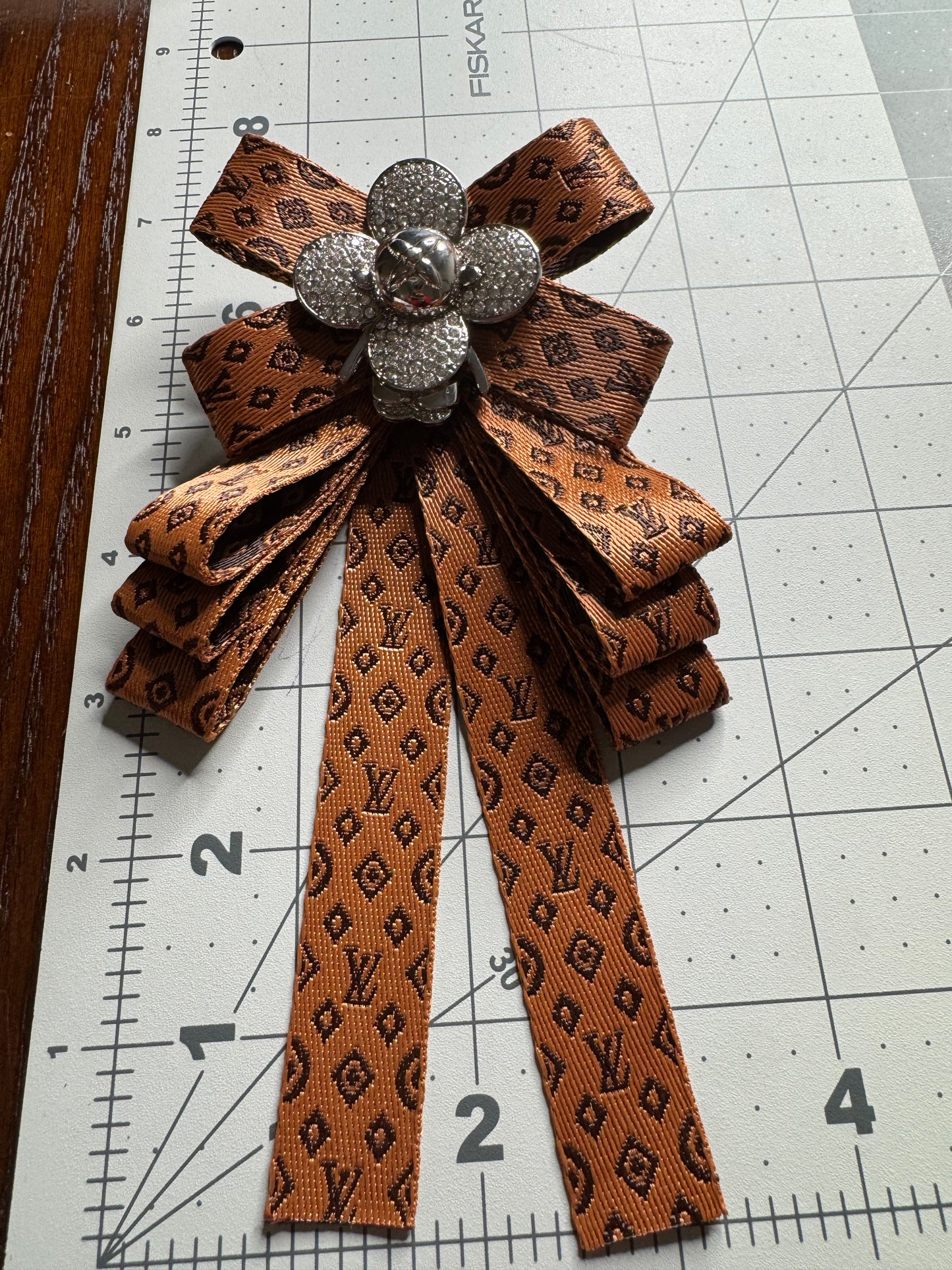 LV bows brooches
