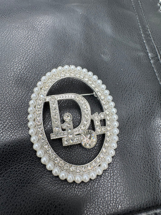 DIO.R Brooch