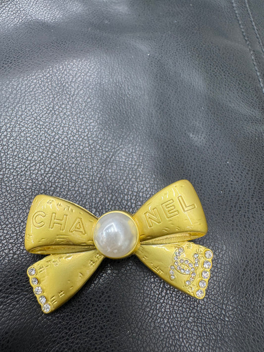 CC bow brooch