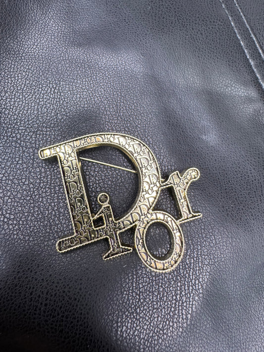 DIO.R Brooch