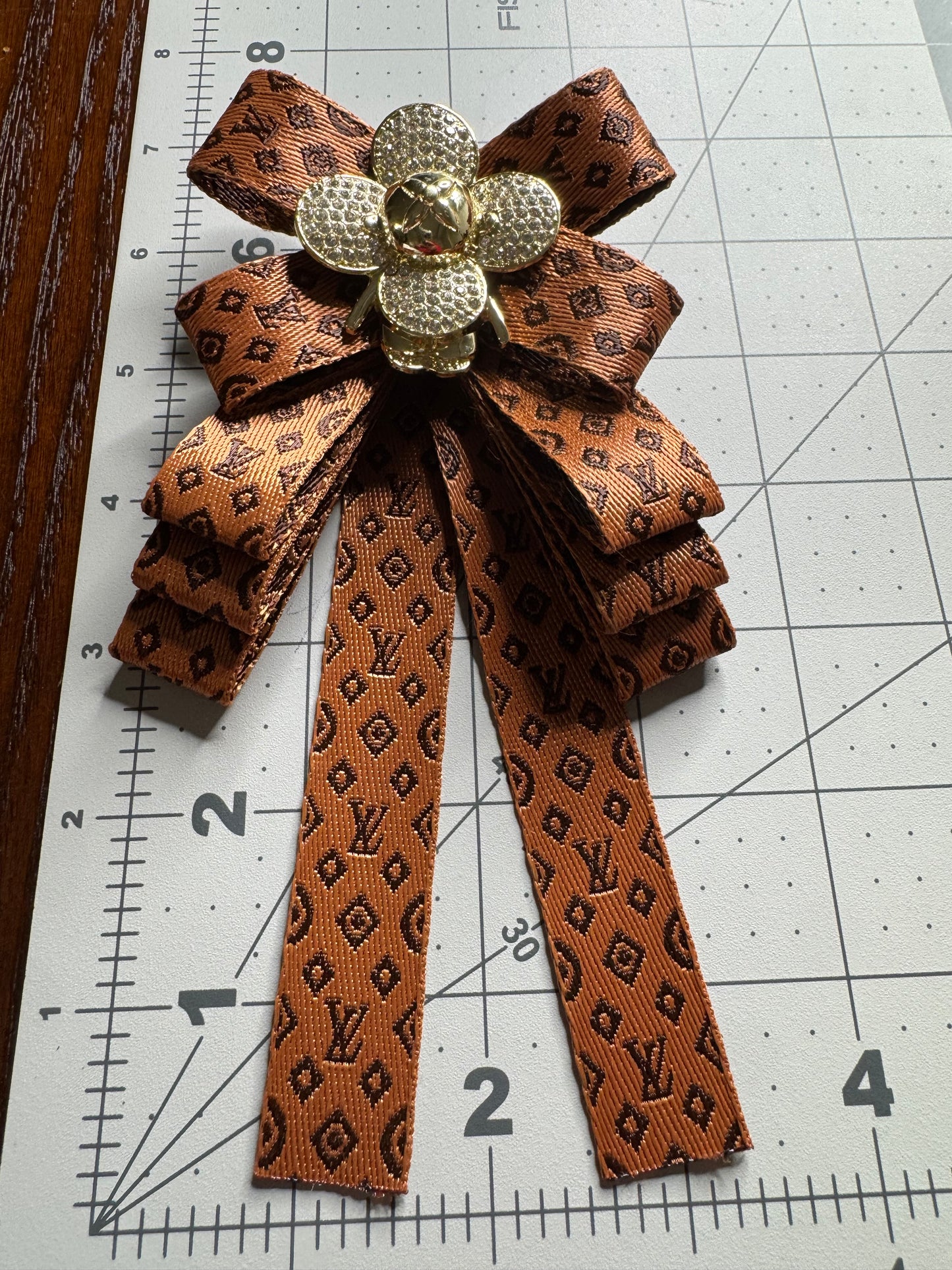 LV bows brooches